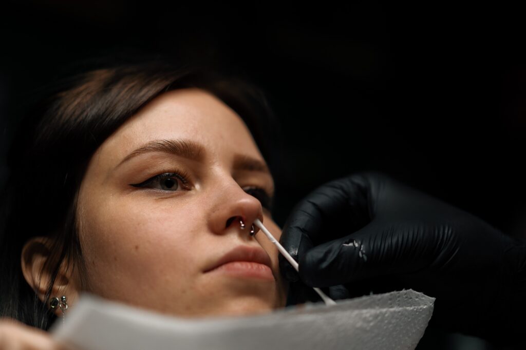 Piercing studio nose piercing for girl after the procedure the master processes septum